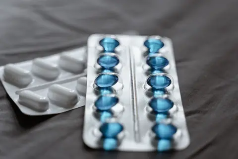 A blister pack of blue capsules